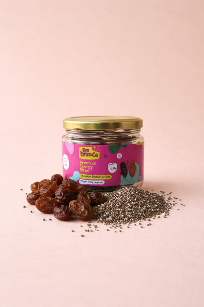 Pro Bites Co Munakka Badam Chia jar beside a pile of energy bites and chia seeds